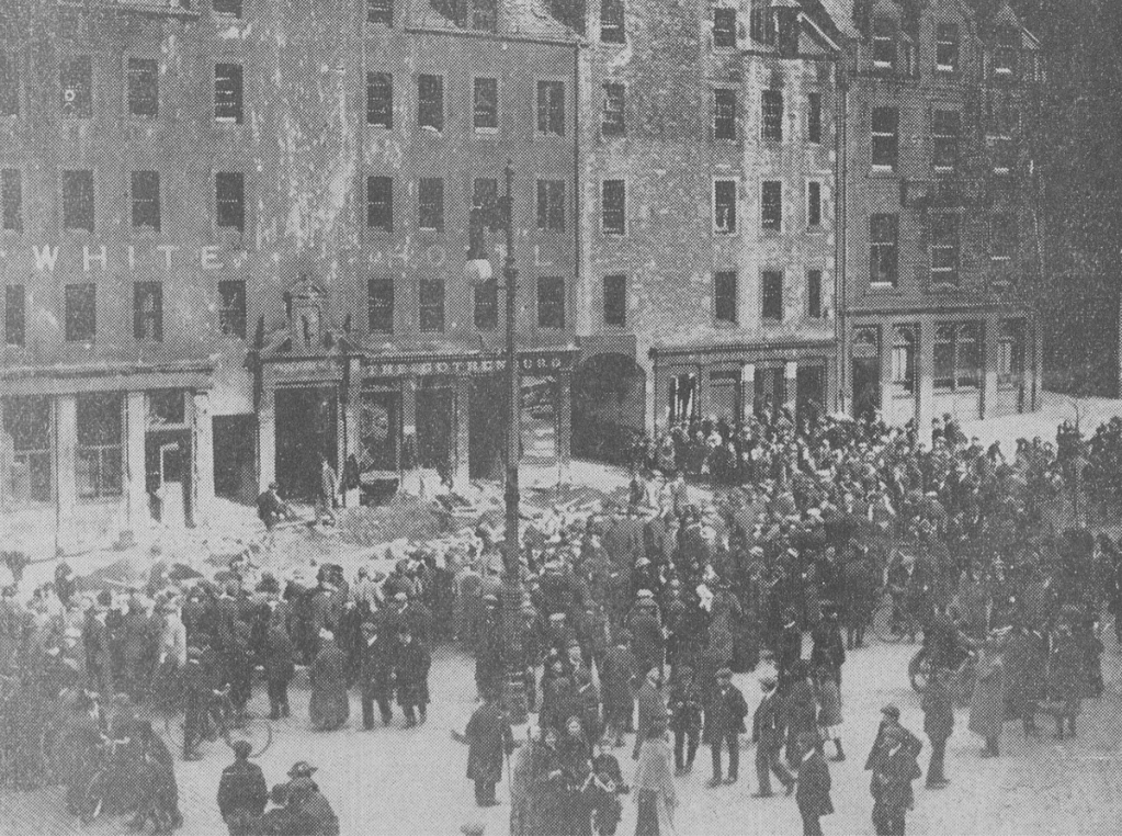 Crowds gather in the Grassmarket the next day to inspect the damage. Note that all the windows are blown out.